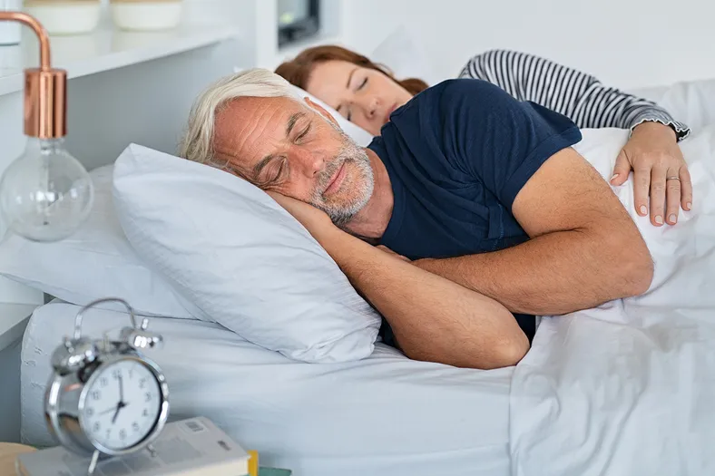 middle aged man sleeping on the couch